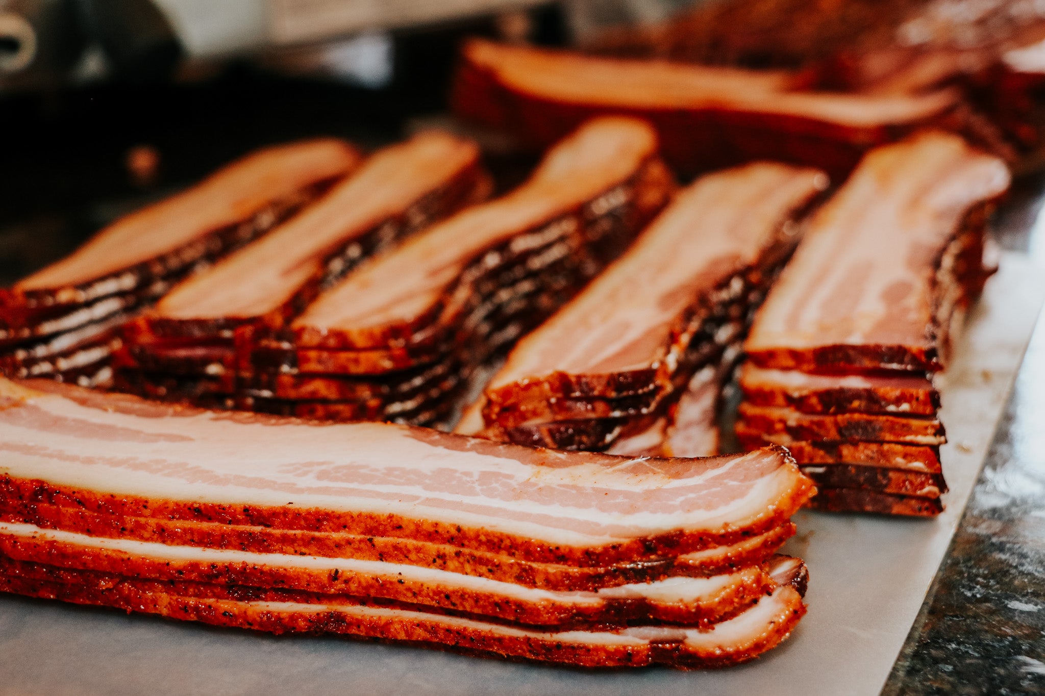 Stacks of sliced bacon on a cutting board