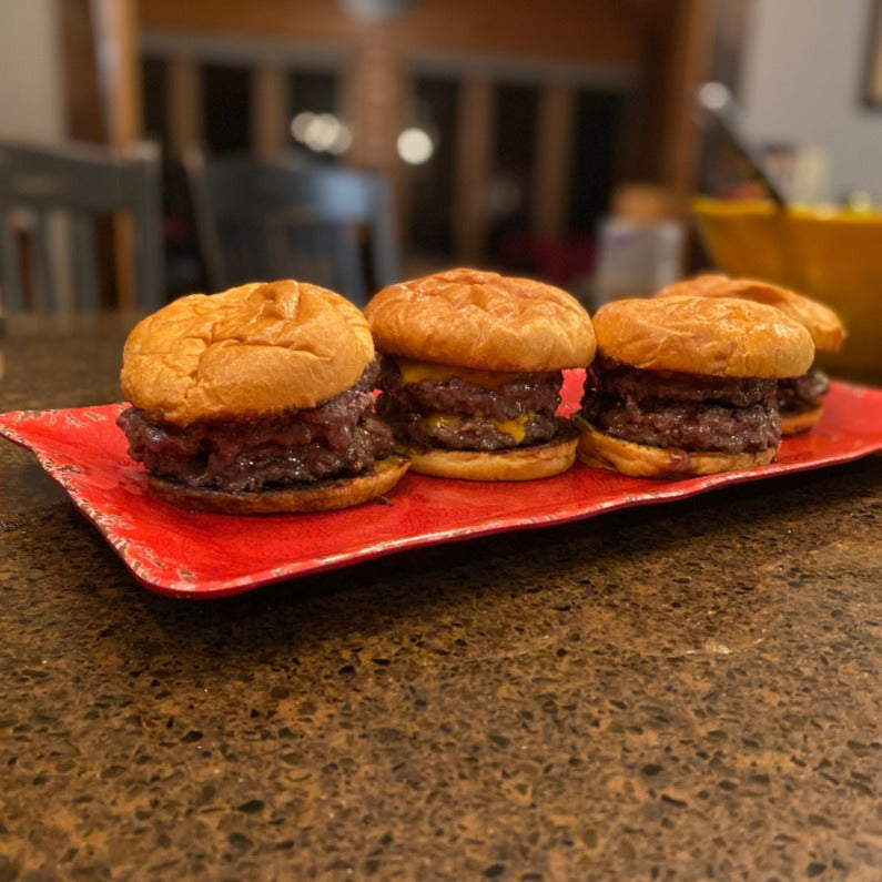 4 half-pound, 2-patty smash burgers made from Verlinde Farms American Wagyu Beef arranged on a tray.