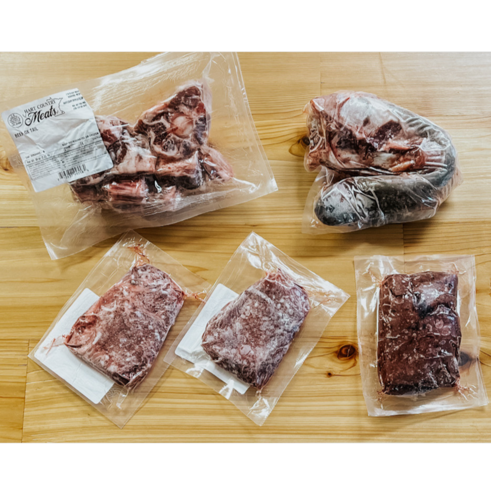 The contents of the Wild Side Box from hart Country Meats, including 1 Beef Liver, 1 Ox Tail, 1 2-Pack of Beef Cheeks, 1 Beef Tongue