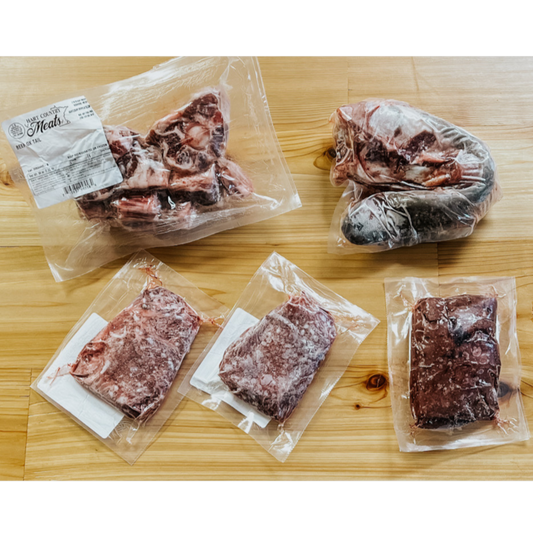 The contents of the Wild Side Box from hart Country Meats, including 1 Beef Liver, 1 Ox Tail, 1 2-Pack of Beef Cheeks, 1 Beef Tongue