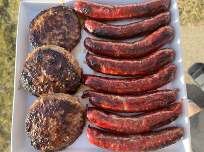 American Wagyu burgers and American Wagyu hot dogs on a plate.