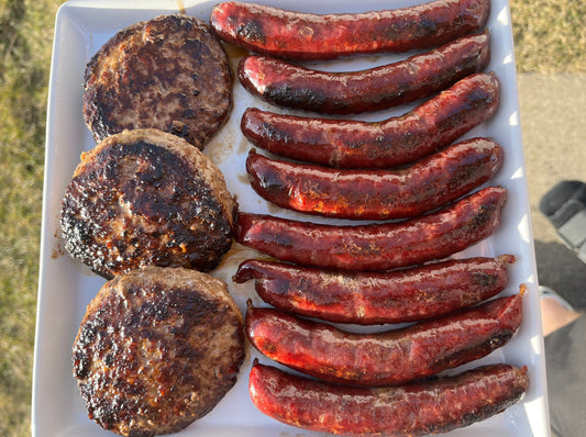 American Wagyu burgers and American Wagyu hot dogs on a plate.