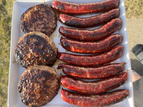 American Wagyu burgers and American Wagyu hot dogs on a plate.