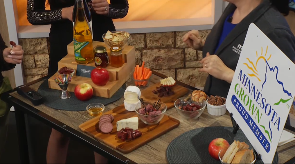 Meats, cheeses, and other accoutrements arranged on a table as part of a segment on how to put together a delicious charcuterie board.