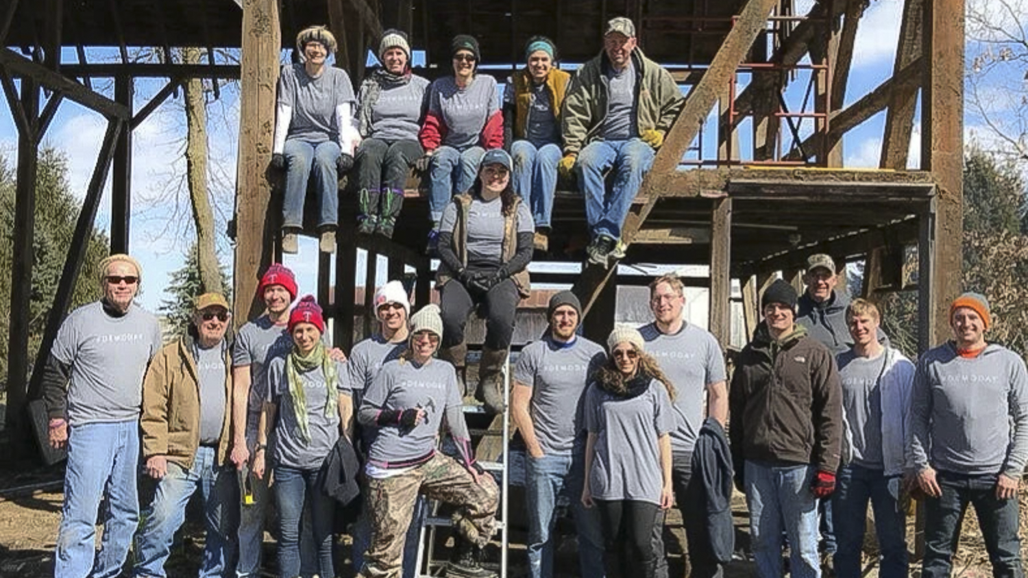 Group of people posing on wooden stairs outdoors