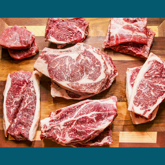 A selection of several wagyu cross steaks from Remmele Custom Beef sitting on a cutting board